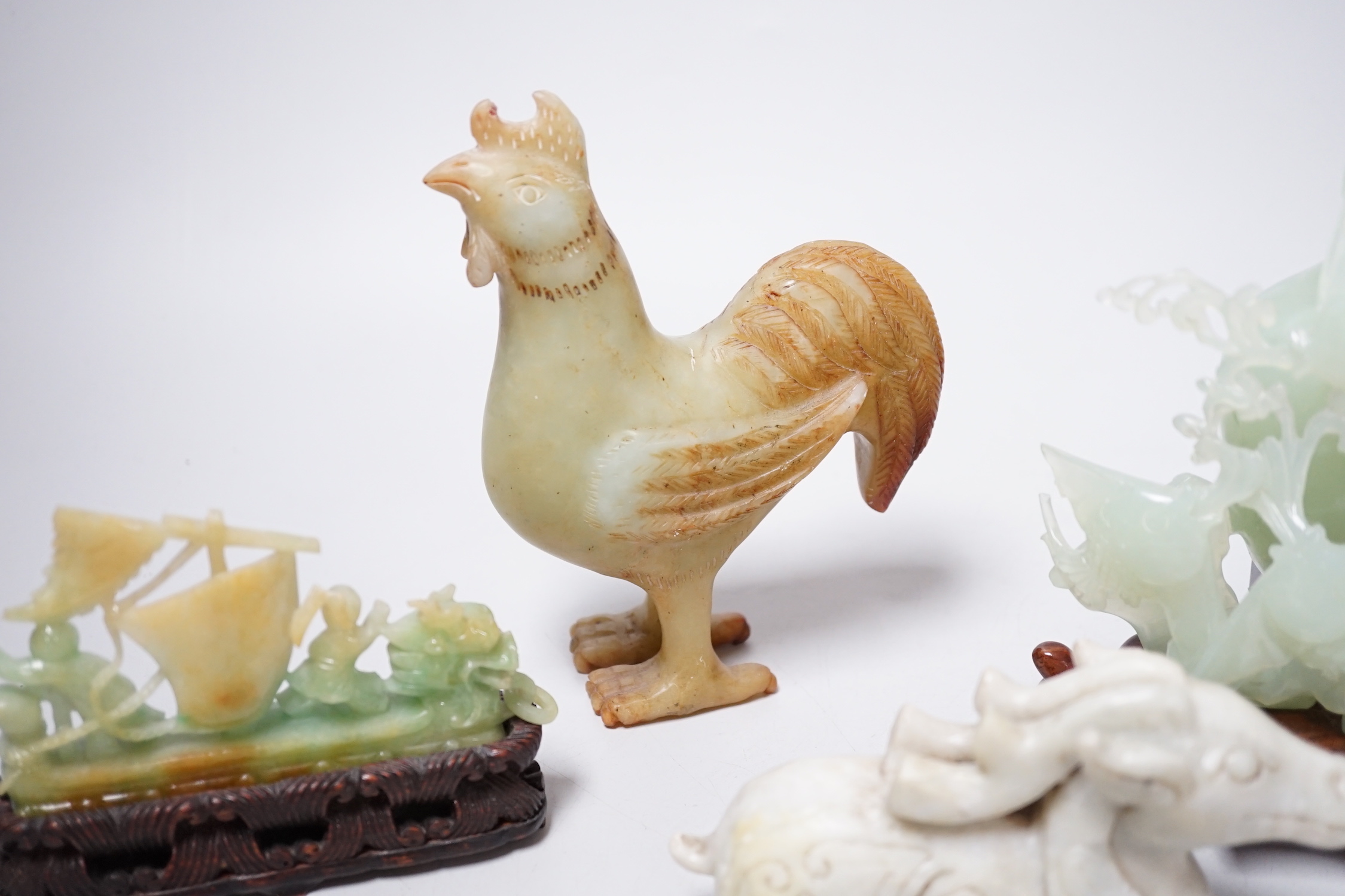 A group of four Chinese bowenite jade and hardstone carvings, the ‘sea creatures’ vase and cover, 18 cm high excluding wood stand
